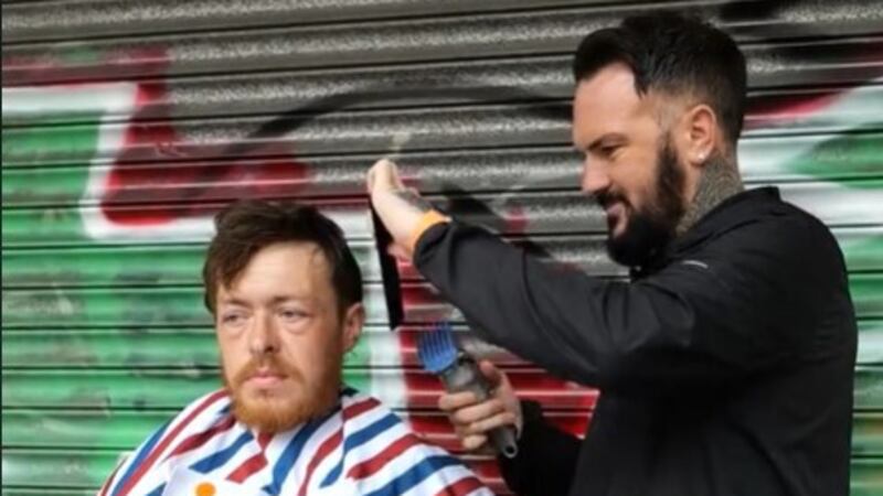 Jason cuts the hair of a homeless friend, Thomas, in Belfast city centre.