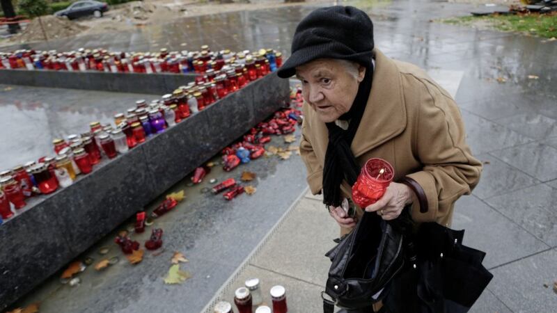 A Bosnian Croat woman lights a candle in memory of Slobodan Praljak, in the southern Bosnian town of Mostar 140 kms south of Sarajevo PICTURE: Amel Emric/AP 