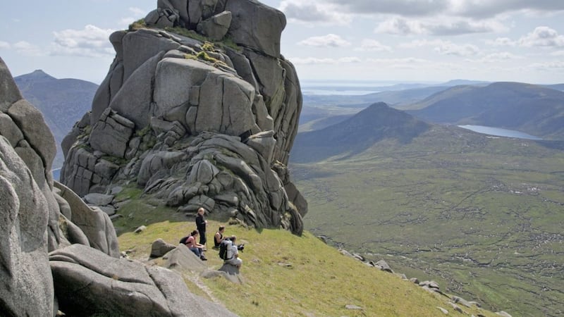 Walkers enjoying a lunch stop on Slieve Bearnagh in the Mourne Mountains Picture: David Doyle 