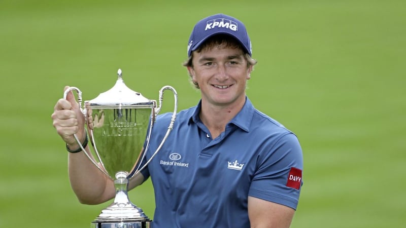 Paul Dunne celebrates with the trophy after his British Masters win 