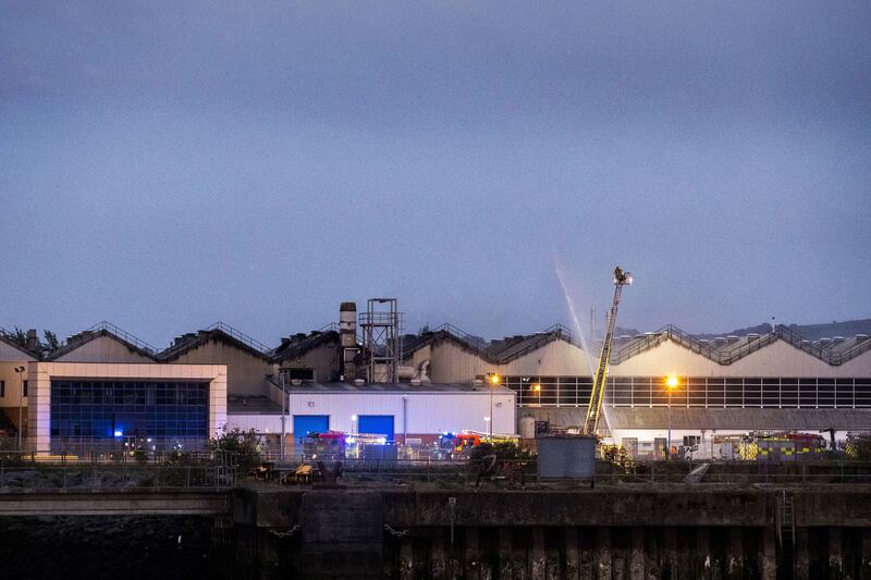 Members of the Fire and Rescue Service on the scene of the Sunday evening blaze at Bombardier in Belfast's Harbour estate. Photo: Liam McBurney/PA Wire.