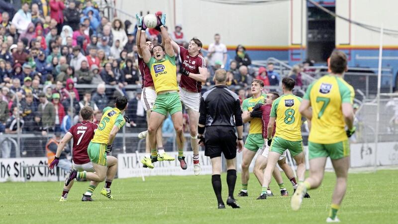 Donegal&#39;s Michael Murphy leaps to the ball ahead of Galway&#39;s Paul Conroy and Thomas Flynn during the All-Ireland Senior Football Championship game on July 22 2017 