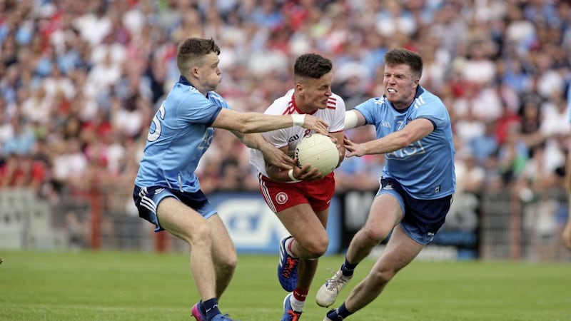 Tyrone&#39;s Michael McKernan tries to burst through two Dublin challenges in yesterday&#39;s Super 8s clash in Omagh 