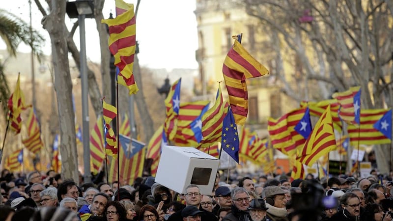 People hold &#39;estelada&#39; or pro-independence flags during a rally in Barcelona earlier this year 