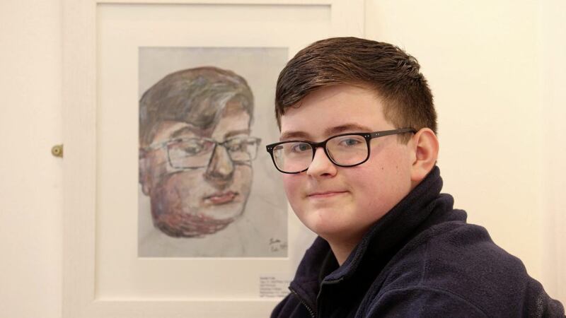 Justin Cole (15), of Dunclug College, Ballymena, with his self-portrait which won second prize. Picture Mal McCann. 