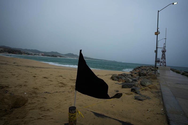 A black flag waves in the wind, signalling a closed beach, in Cabo San Lucas, Mexico