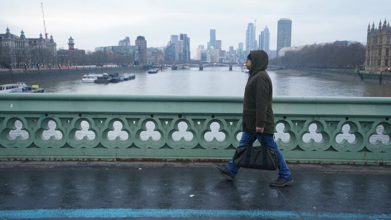 A man walks across Westminster Bridge in central London earlier this year (PA)