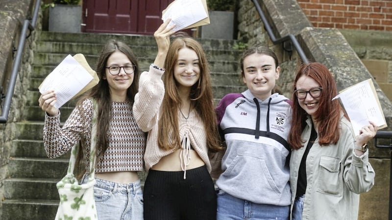 Students at St Dominic&#39;s Grammar School on the Falls Road celebrate exam success. Picture by Hugh Russell 