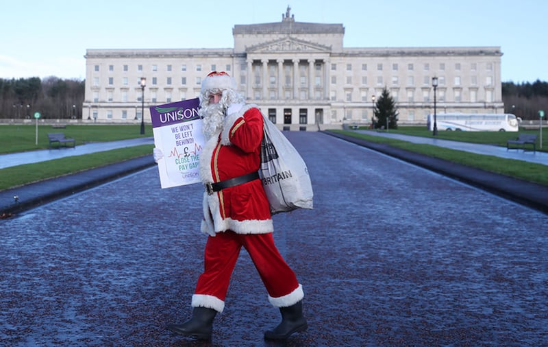 A member of the Health Union Unison protests on the issue of nurses pay as talks to restore the Northern Ireland Powersharing executive begin at Stormont in Belfast. Picture by Niall Carson/PA Wire&nbsp;