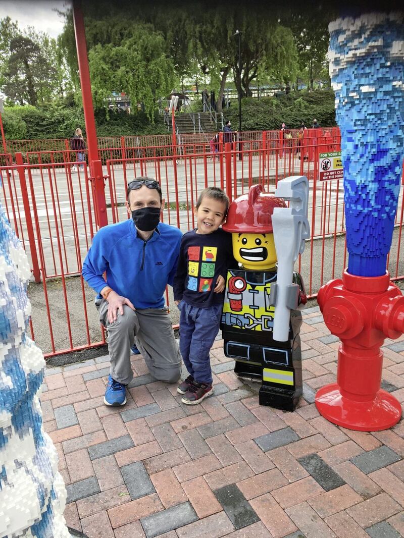 Neil Lancefield and his nephew Liam meet a firefighter at Legoland Mythica. Picture by PA Photo/Neil Lancefield 