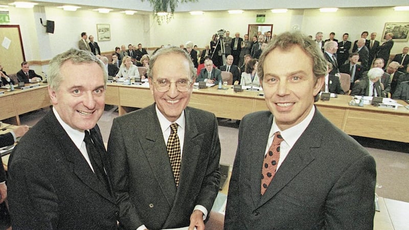 British Prime Minister Tony Blair, pictured right, with US Senator George Mitchell, pictured centre, and Taoiseach Bertie Ahern smiling after they signed the historic agreement for peace in Northern Ireland on April 10 - Good Friday - in 1998. Pool photo by Dan Chung 