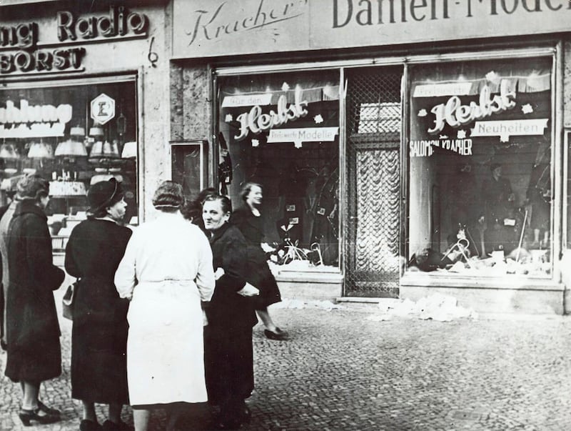 People outside a Jewish-owned shop in an unnamed German town after the Kristallnacht, when Nazi-incited mass riots left more than 91 jews dead, damaged more than 1,000 synagogues and left some 7,500 Jewish businesses ransacked and looted