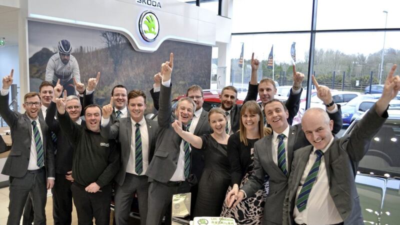 Staff at John Mulholland Motors celebrate the Skoda dealership&#39;s unique industry treble 