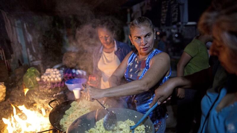 Women cook dinner for Hondura&#39;s migrants at a makeshift shelter in Ciudad Hidalgo, Mexico Picture by Rodrigo Abd/AP 