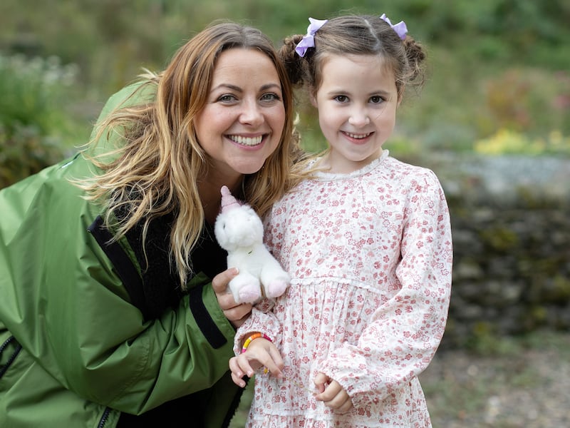 Charlotte Church standing with Harper, the youngest member of the choir
