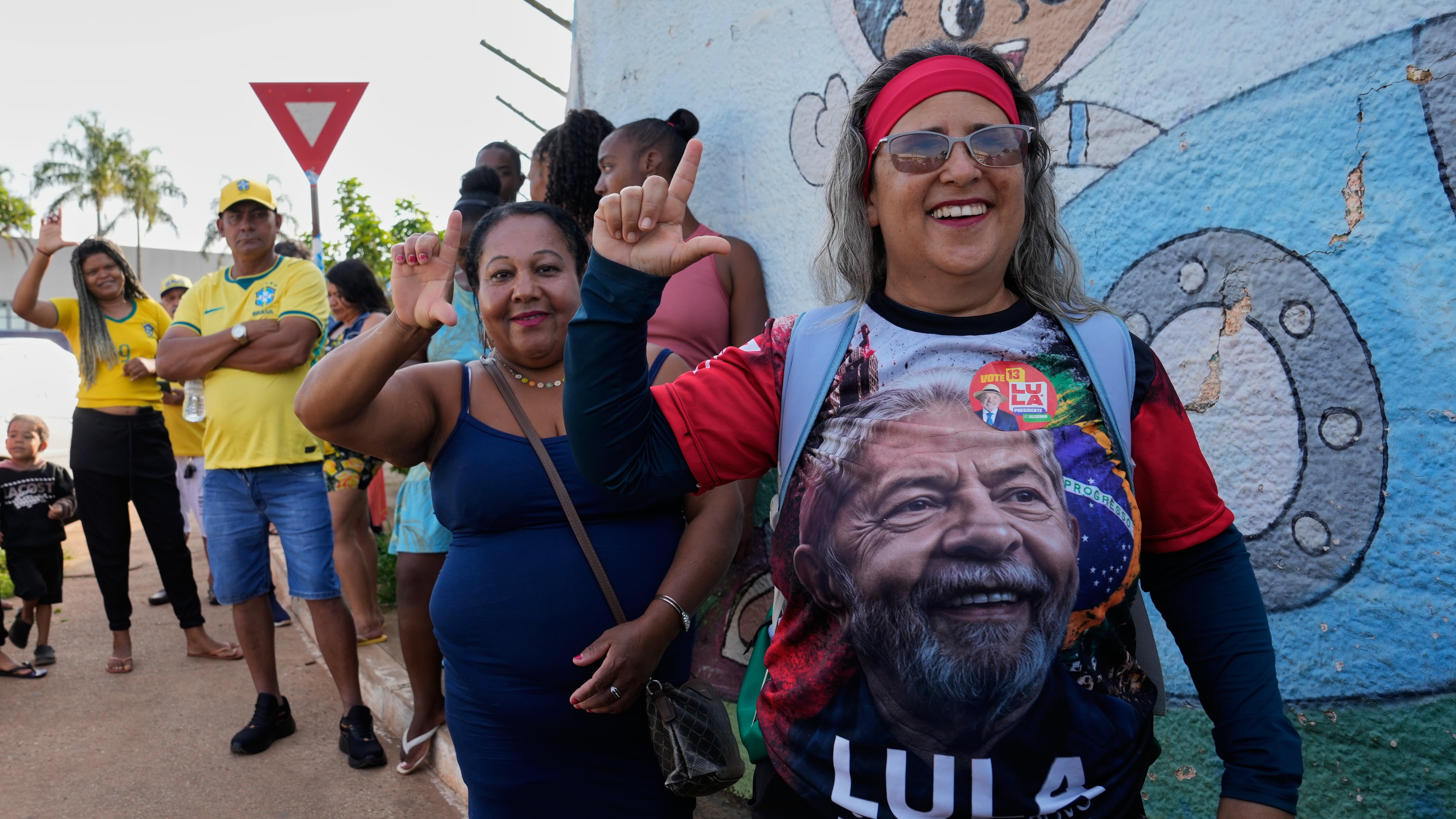 A supporter of President Luiz Inacio Lula da Silva lines up at a polling station in Brasilia (Eraldo Peres/AP)