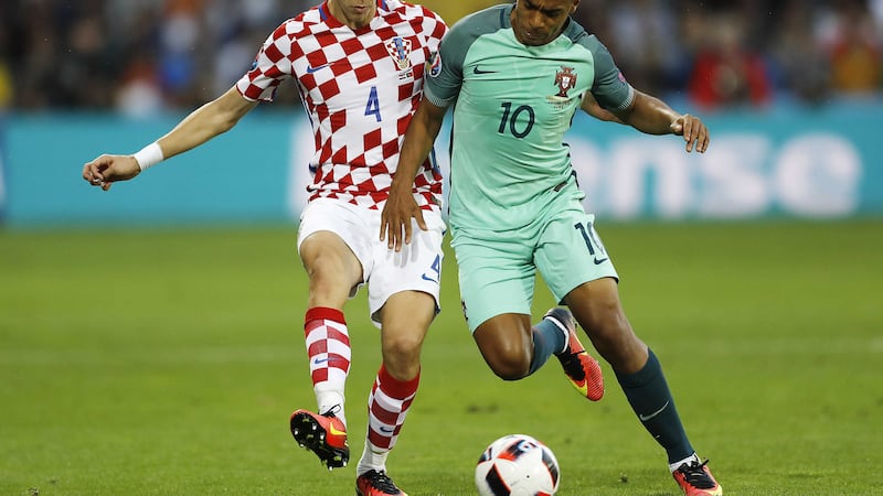 &nbsp; Portugal's Joao Mario&nbsp;and Croatia's Ivan Perisic&nbsp;vie for the ball<br />Picture by PA