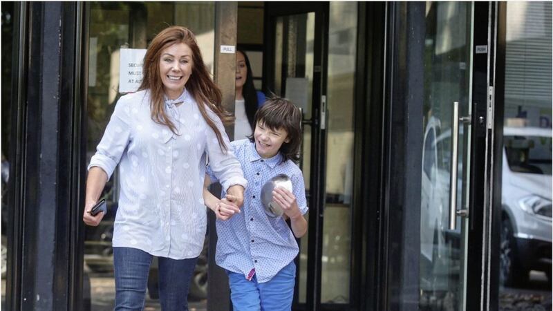 Billy Caldwell and his mother Charlotte on the way out of the Department of Health at Stormont. Picture by Hugh Russell 