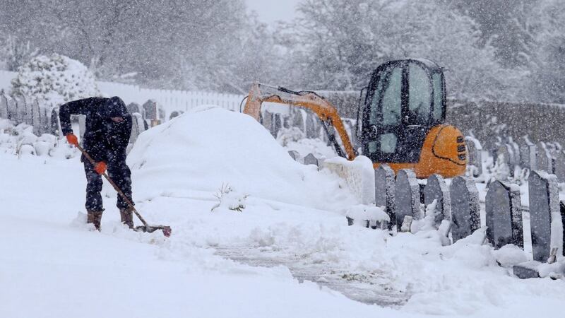 Clearing the pathways of snow at Our Ladys&Acirc;&nbsp;Cemetery,&Acirc;&nbsp;Hannahstown Picture Mal McCann. 