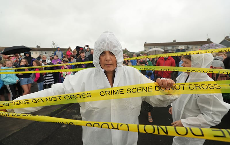 A group of activists put up crime scene tape as people gather to protest at the site of the former Tuam home for unmarried mothers in County Galway, where a mass grave of around 800 babies has recently been uncovered&nbsp;