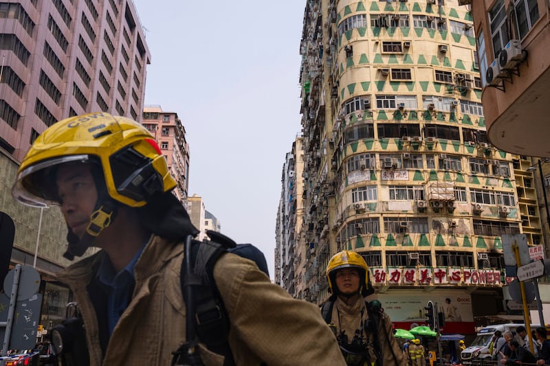 Firefighters at the scene of the blaze in Hong Kong (Louise Delmotte/AP)
