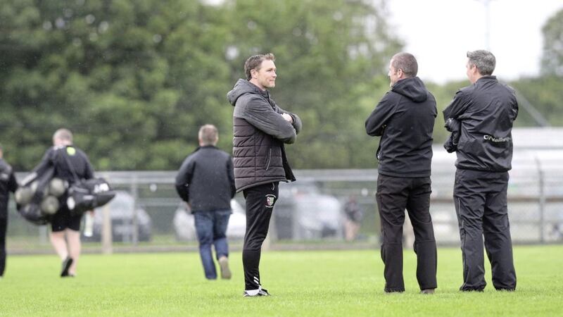 Former Tyrone team-mates - Swatragh manager Enda McGinley and St Canice&#39;s Dungiven manager Stephen O&#39;Neill - catch up following the Derry Senior Football Championship match at Swatragh earlier this year. The pair will work together in Antrim Picture Margaret McLaughlin 