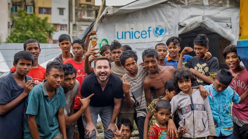 Martin Compston and children at Kamalapur Street Hub in Dhaka, which is supported by Unicef (Unicef/KM Asad/PA)