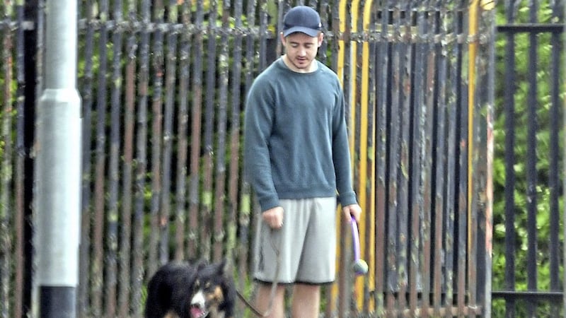 Paddy Jackson walking a dog earlier this week in Belfast. Picture by Alan Lewis/Photopress