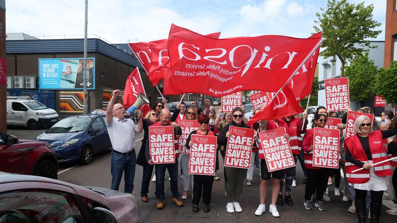 Nipsa members on strike at the Shankill Wellbeing and Treatment Centre block the road for a short period. PICTURE: MAL MCCANN