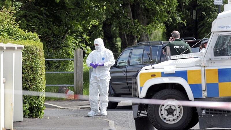 Police and forensics at the scene where a bomb was found under the car of a serving PSNI officer in Eglinton, Co Derry, in June 2015. File picture by Margaret McLaughlin 