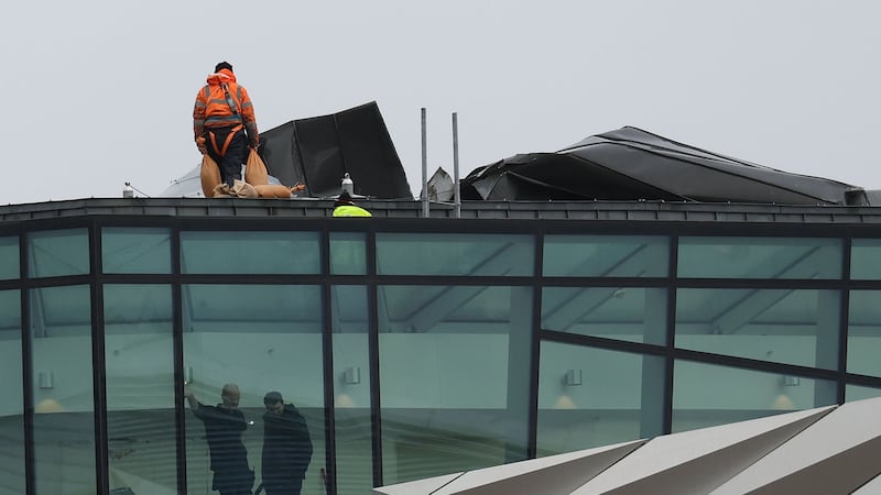 Repairs underway to the roof of Titanic Belfast Tourist attraction on Tuesday after it was damaged in the storms.
All Counties where  severely affected by Storm Isha on Sunday and Monday.
A further yellow weather warning for wind begins at 16:00 GMT on Tuesday.
PICTUERE: COLM LENAGHAN