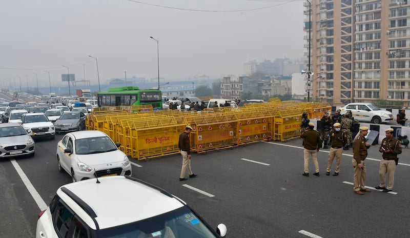 Police barricade a major highway at Ghazipur near New Delhi to stop thousands of protesting farmers from entering the capital (AP)