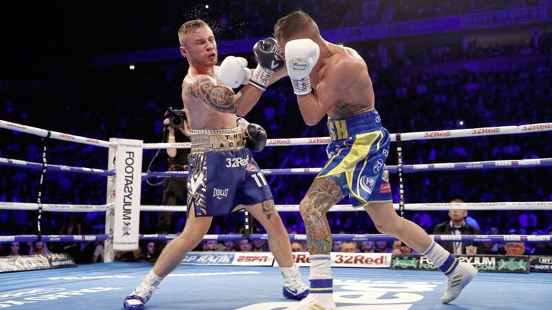 Josh Warrington (right) and Carl Frampton in action in the IBF Featherweight Championship at Manchester Arena. 