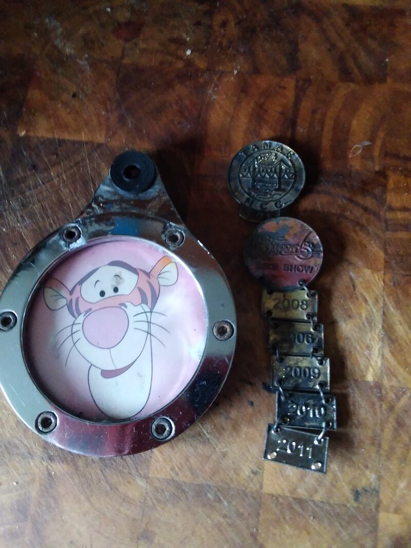 A picture of Tigger and pin badges which were retrieved from the bike 