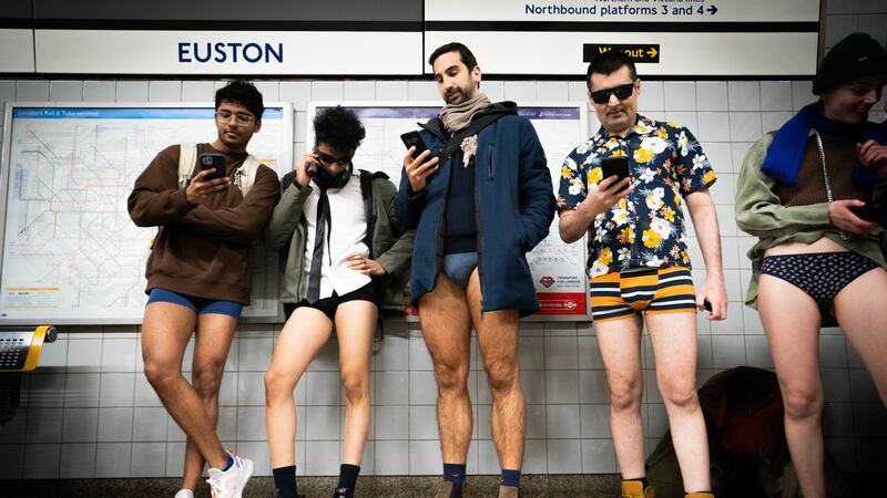 People at Euston station in London as they take part in the annual No Trousers Tube Ride