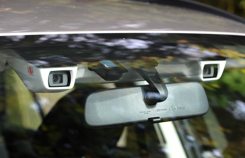 Car windscreen with safety cameras beside the rear-view mirror