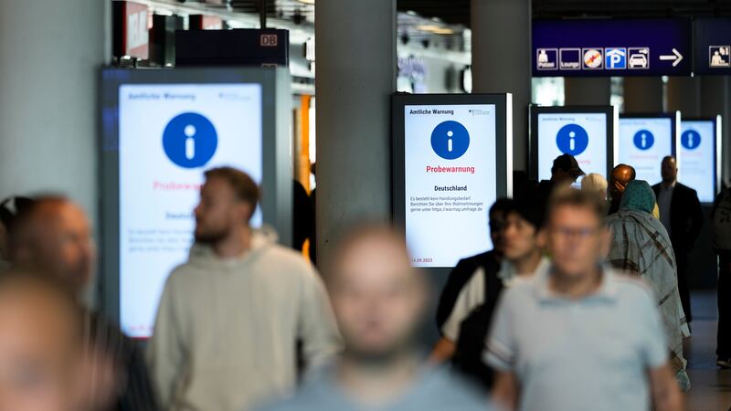 Screens displayed the test alarm message at a train station in Berlin (Markus Schreiber/AP)