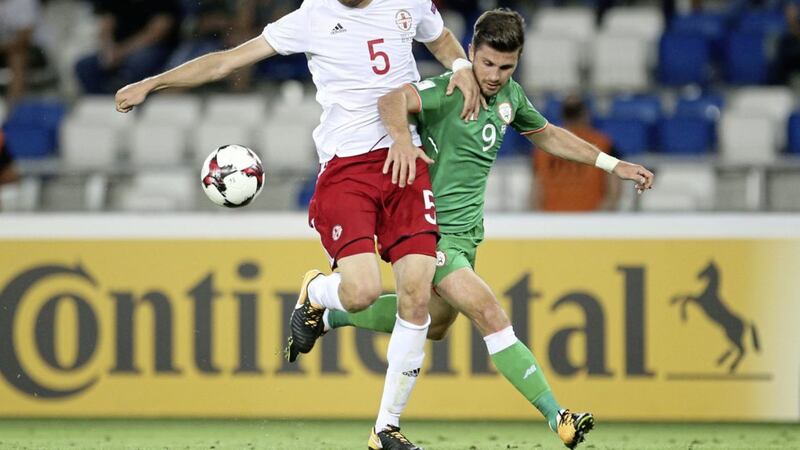 Georgia&#39;s Solomon Kverkvelia (left) and Republic of Ireland&#39;s Shane Long battle for the ball during their World Cup qualifier in 2017 The game finished 1-1 