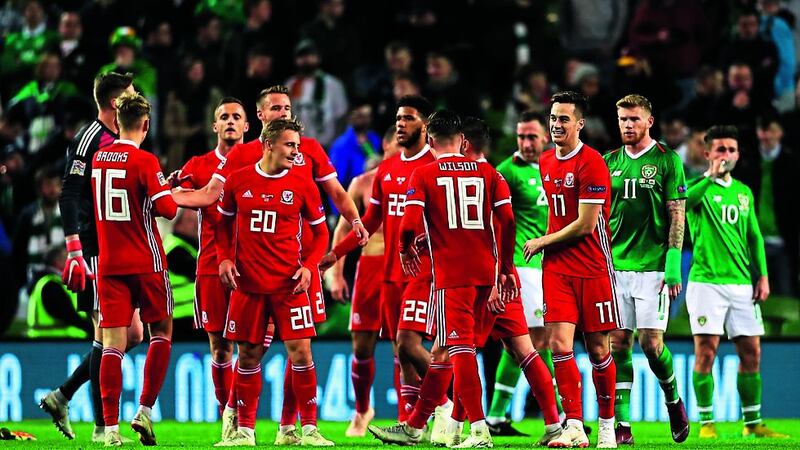 Wales players celebrate Harry Wilson's winning free kick at the Aviva