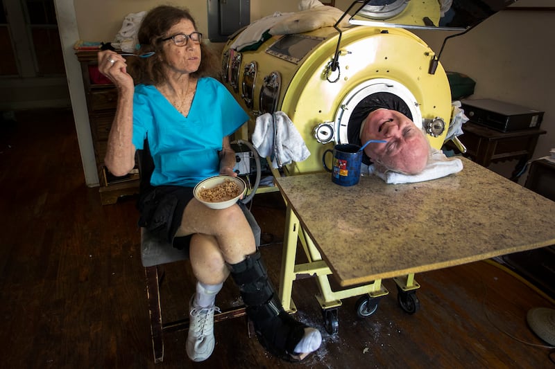 Paul Alexander with his carer and friend, Kathryn Gaines, at his home in Dallas (Smiley N. Pool/The Dallas Morning News via AP)