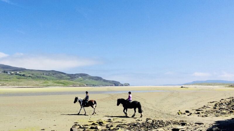 Horse riding on the beach in Co Donegal - just one of the many holiday at home options on offer this summer 