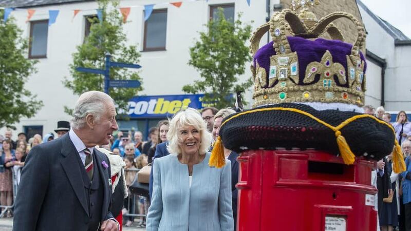 Charles and Camilla view a crochet mailbox topper during a tour of the market square in Selkirk (Lisa Ferguson/PA)