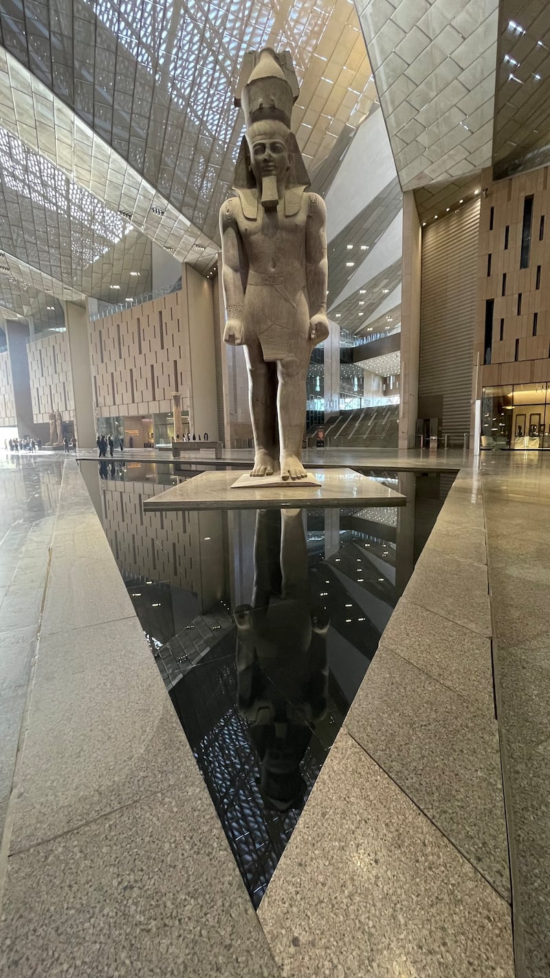 The statue of Ramses II welcomes visitors to the giant lobby of the Grand Egyptian Museum