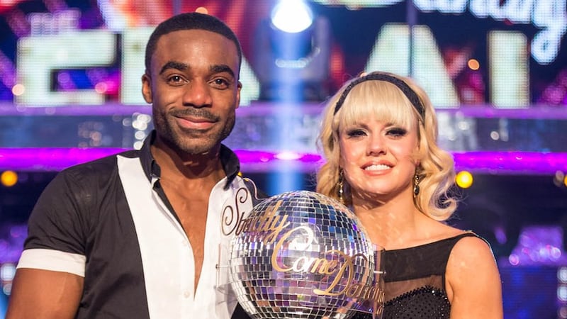 Joanne Clifton and Ore Oduba holding the Strictly Come Dancing glitterball trophy