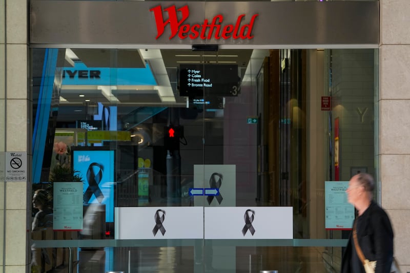 A man walks past the entrance to the Westfield shopping centre (Mark Baker/AP)