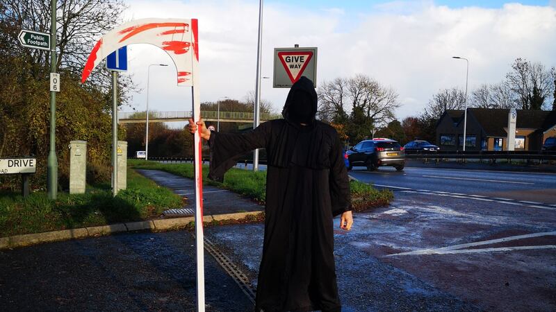The foreboding figure has been pictured at a busy intersection, complete with scythe and long dark robes.