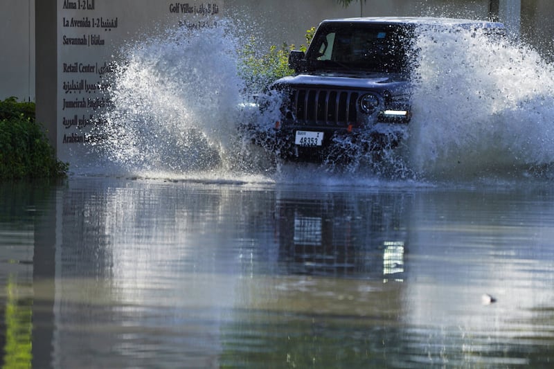 An SUV drives through floodwater covering a road in Dubai, United Arab Emirates (AP/Jon Gambrell)