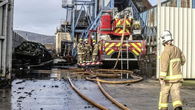 More than 40 firefighters were yesterday continuing to fight a large fire at a scrap metal recycling site in the docks area of Belfast. Picture by Hugh Russell 