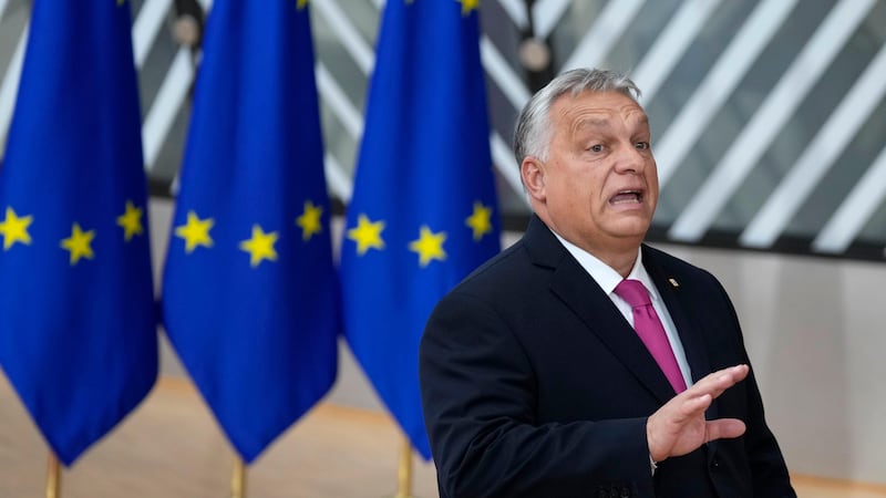 Hungary’s Prime Minister Viktor Orban speaks to the media as he arrives for an EU summit in Brussels (Virginia Mayo/AP)