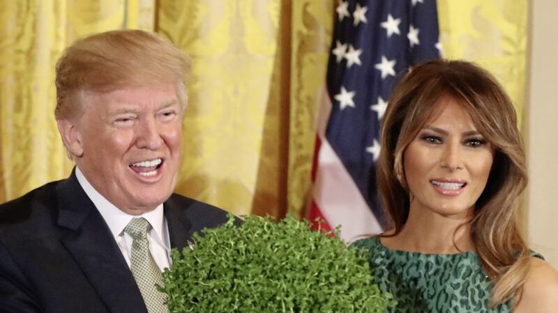 US President Donald Trump holds a bowl of shamrock presented to him by Irish Taoiseach Leo Varadkar as Melania Trump looks on during the annual presentation ceremony at the White House in Washington. Picture by Niall Carson/PA 